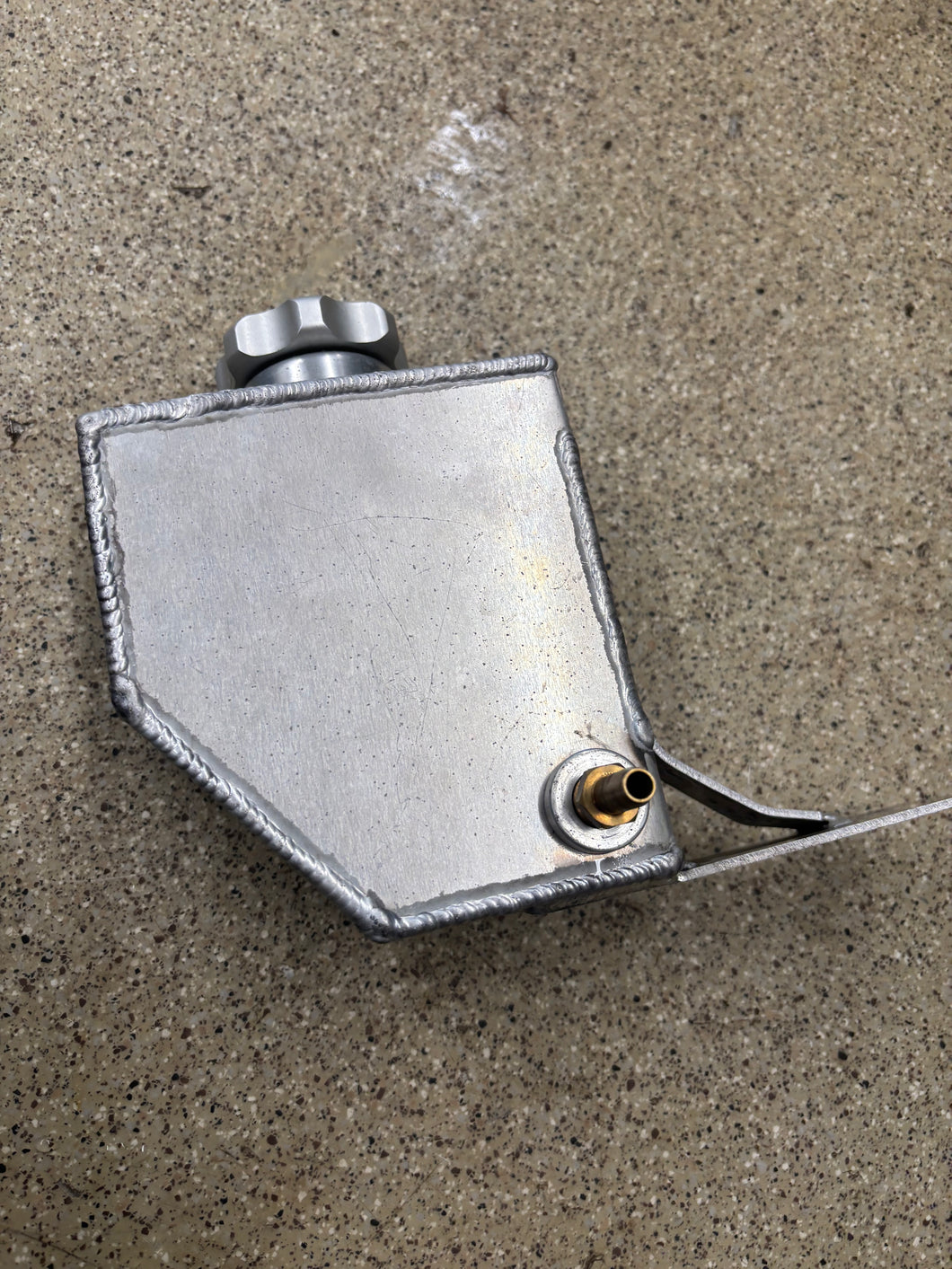 Gamble garage Overflow tank screw on top.